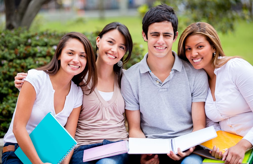 Group of university students outdoors looking happy