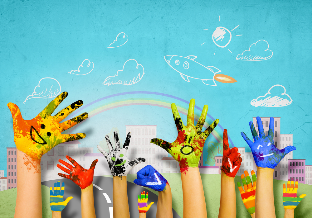 Human hands in colorful paint showing symbols